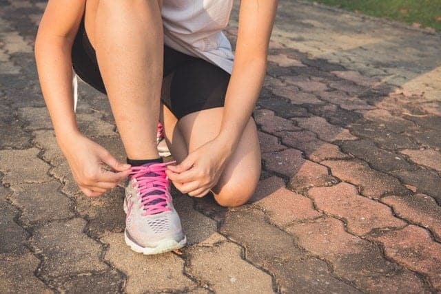 woman tying shoes