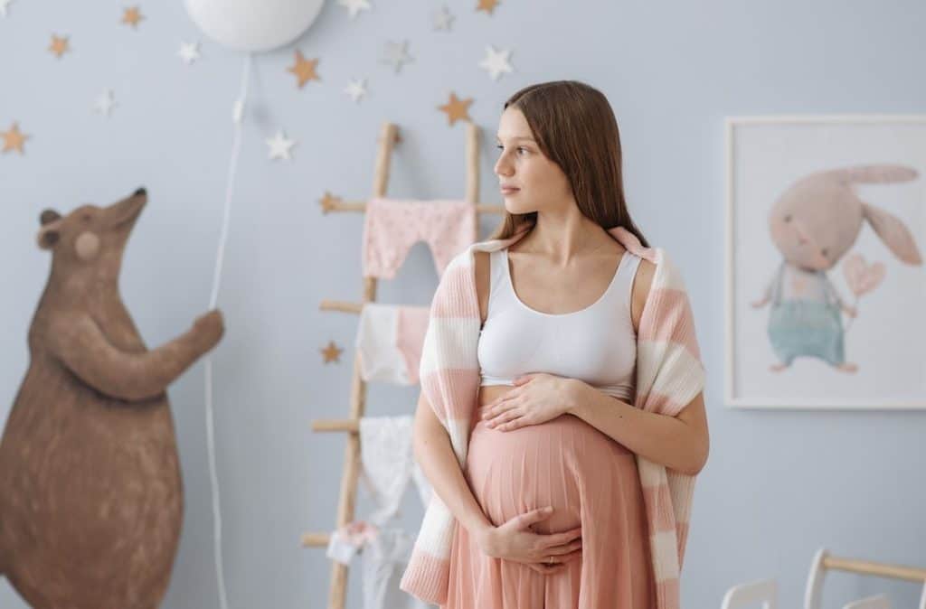 beautiful pregnant woman holding her belly