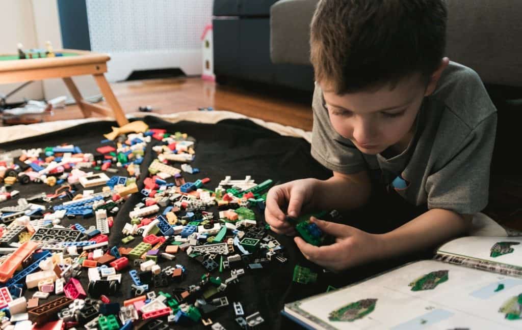 boy playing with legos