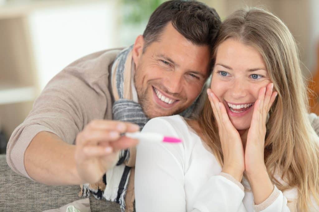 couple looking at a pregnancy test
