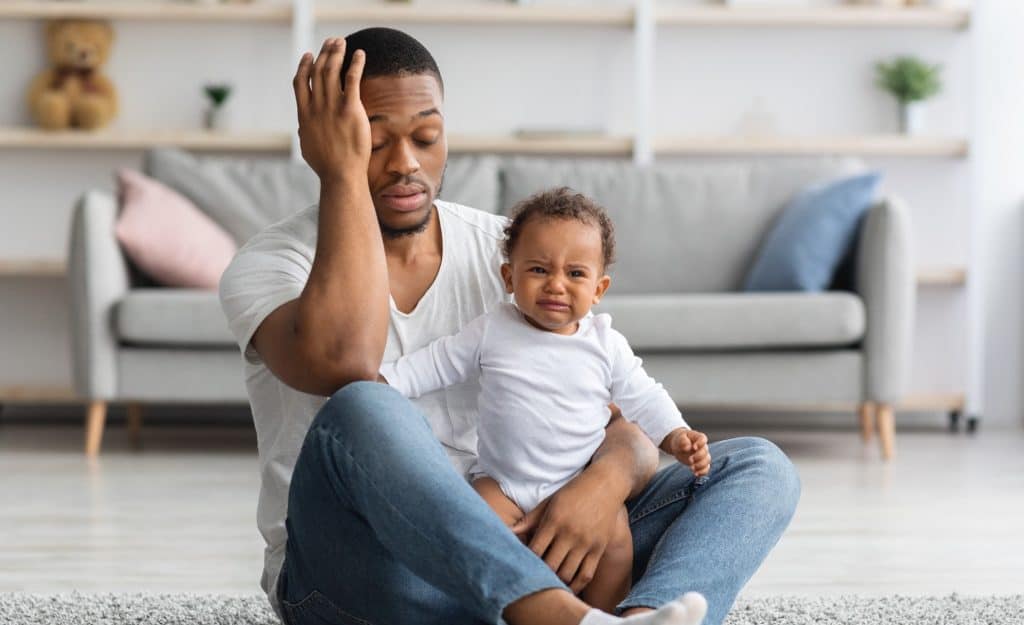 dad holding crying baby