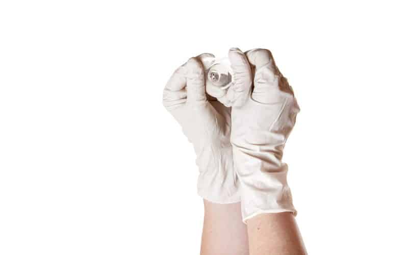 gloved hands holding nipple shield