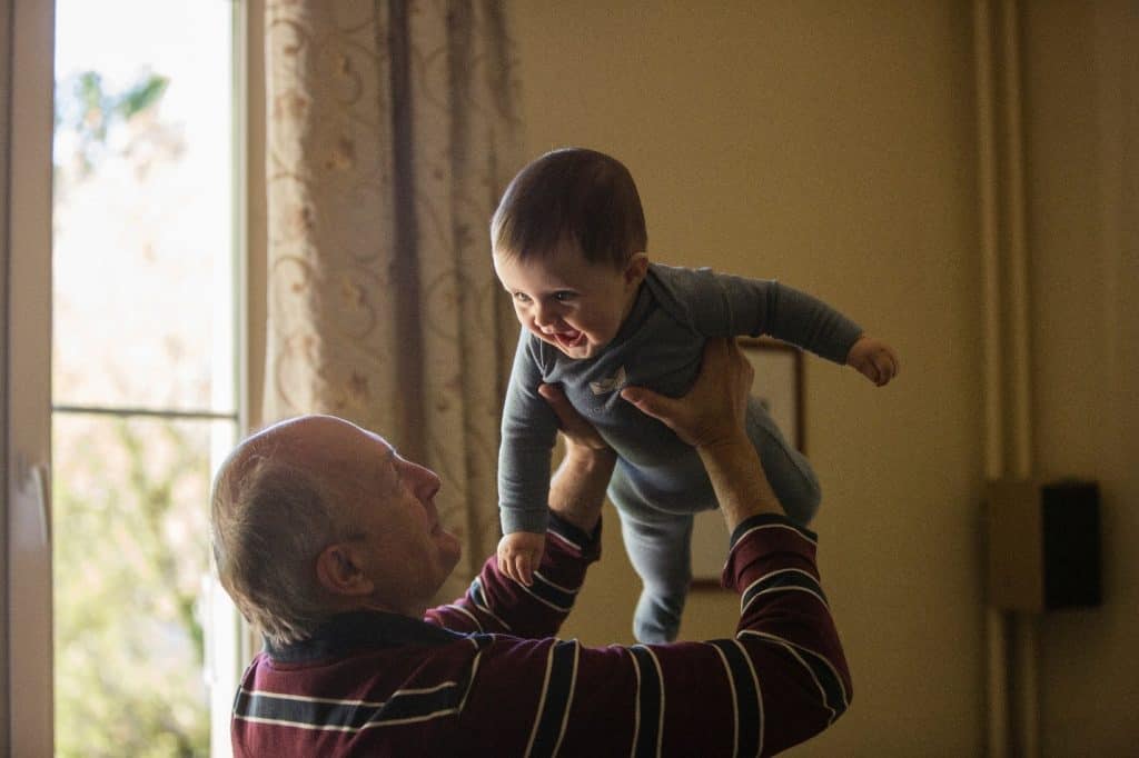 grandpa carrying baby