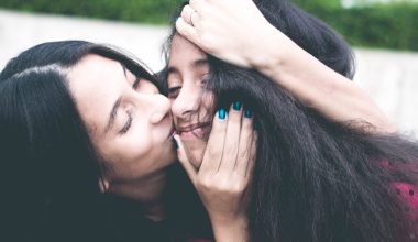 mom kissing her daughter