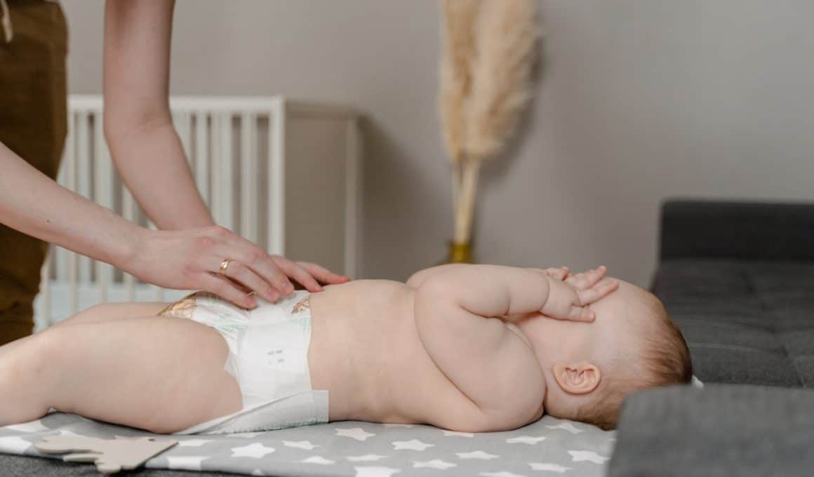 mother changing baby diaper