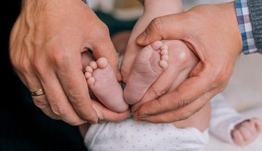 parents holding baby's feet
