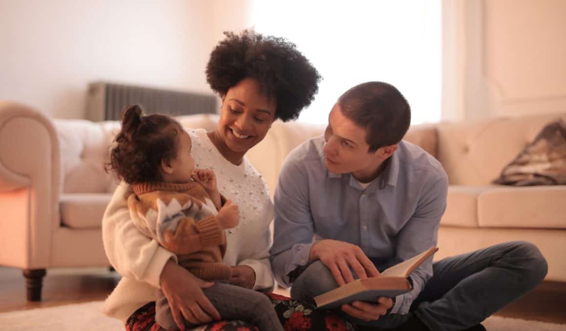 parents reading to their baby