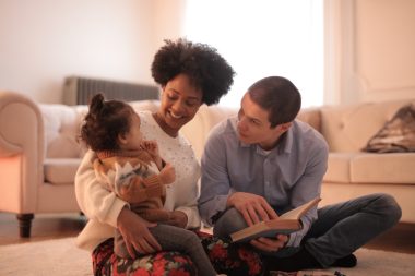 parents reading to their baby