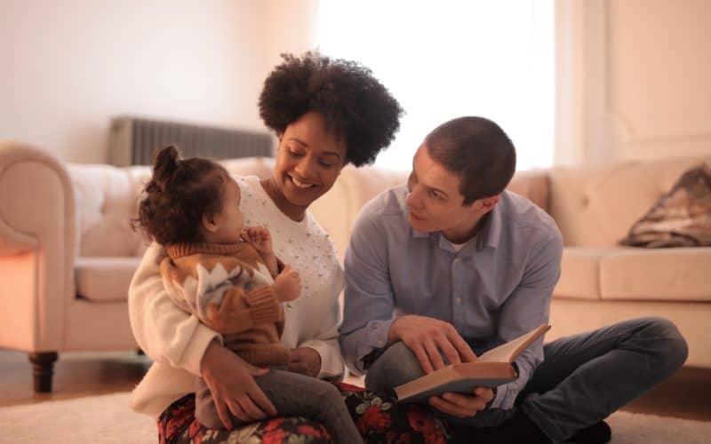 parents reading to their baby