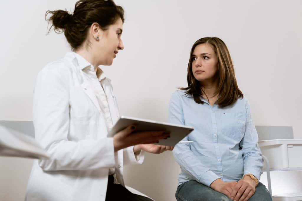 pregnant woman talking to doctor