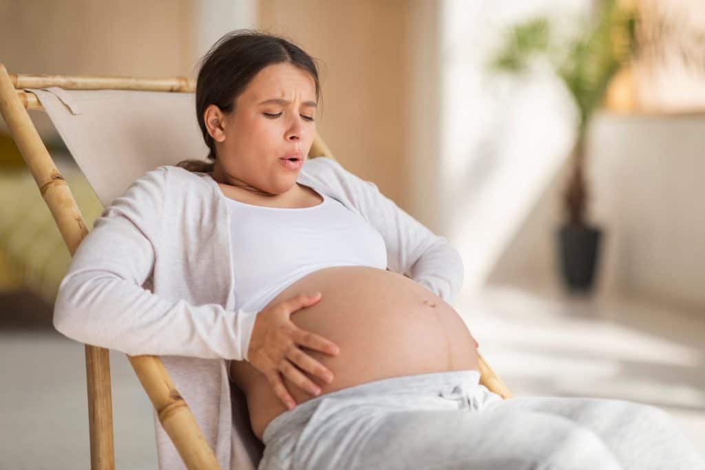 pregnant woman touching her belly