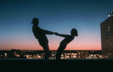 silhoutte of couple holding each other's hand