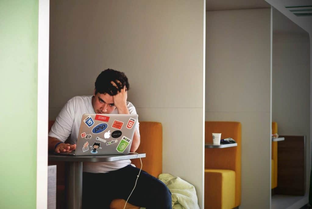 stressed out man working on his laptop