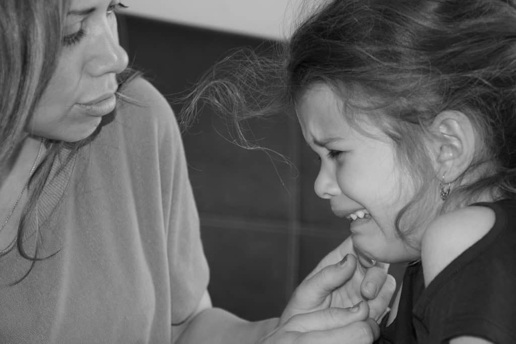 woman consoling crying child