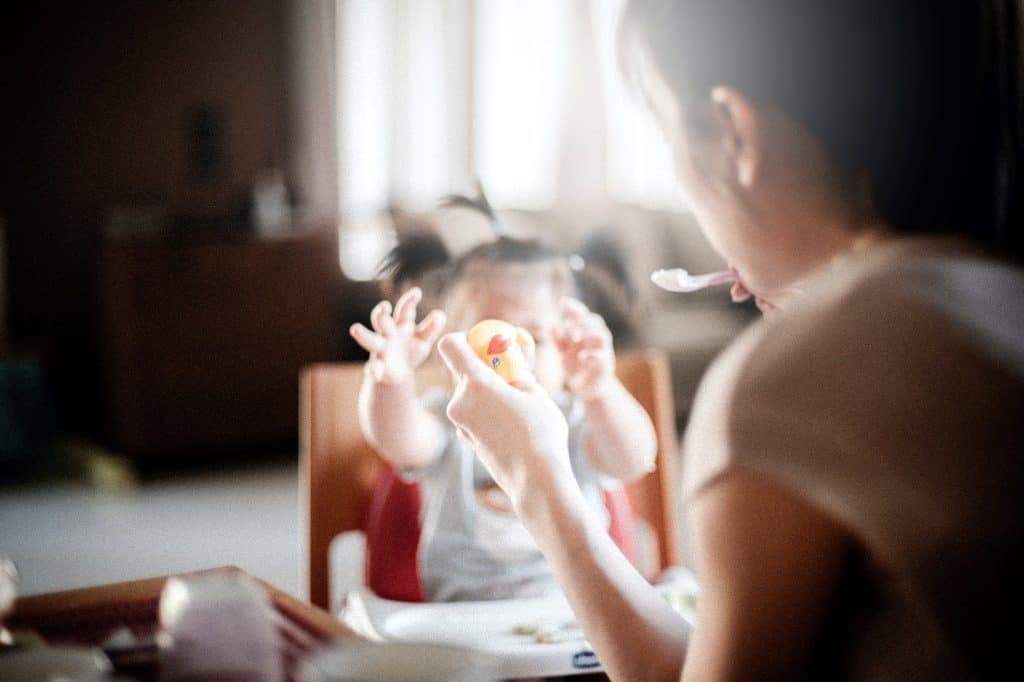 woman feeding baby