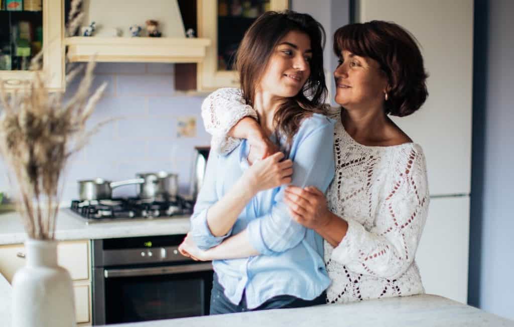 woman hugging her daughter