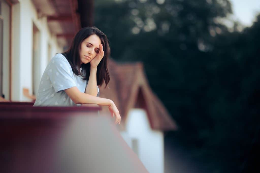 woman in balcony having a headache