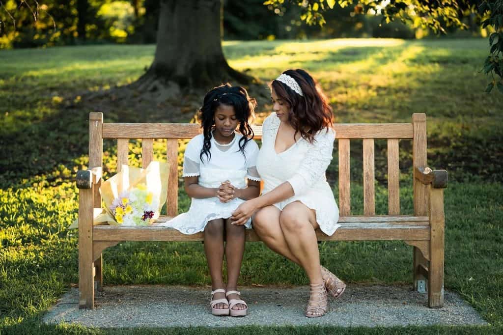 woman sitting on a bench with girl