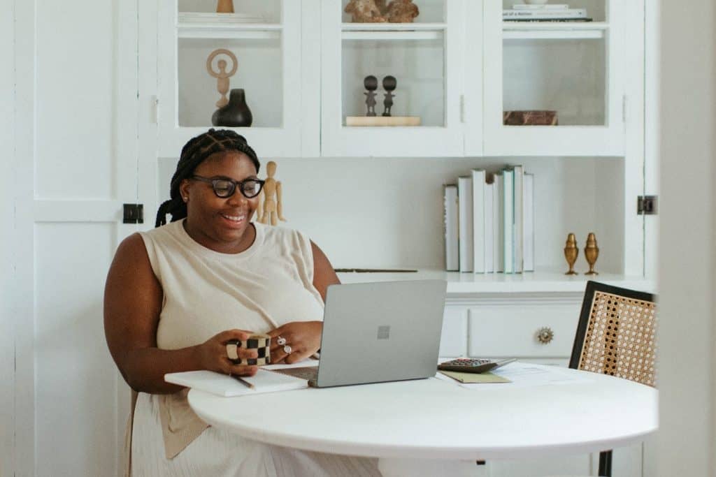 woman smiling in front of her laptop