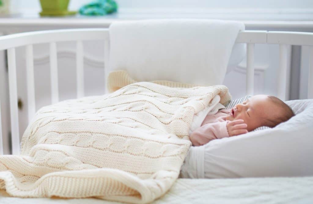 baby on co-sleeper crib