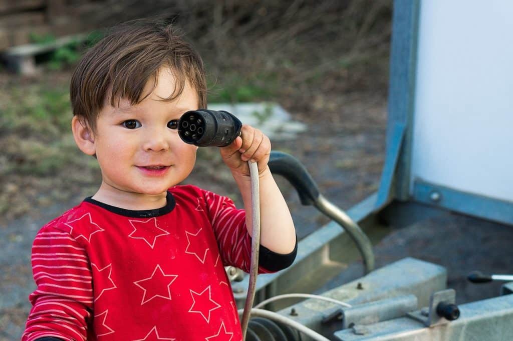 boy holding a plug