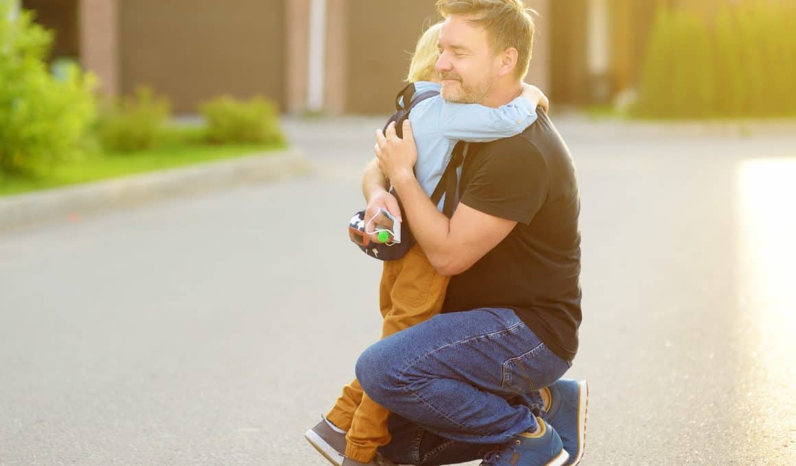 boy hugging father