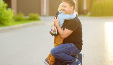 boy hugging father