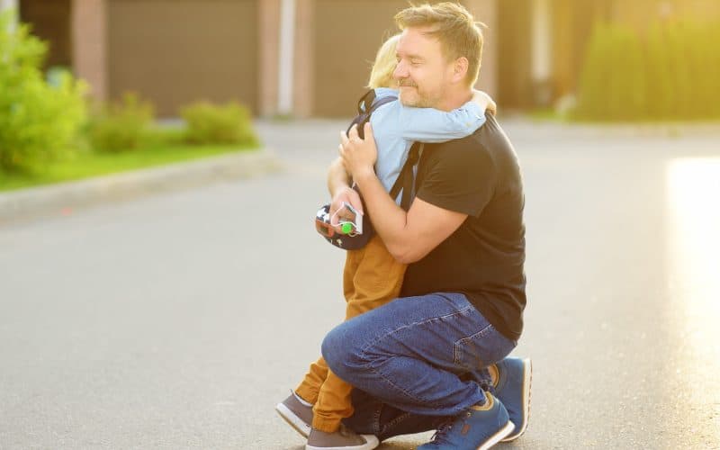 boy hugging father