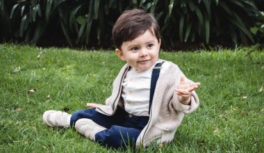 cute toddler sitting on grass