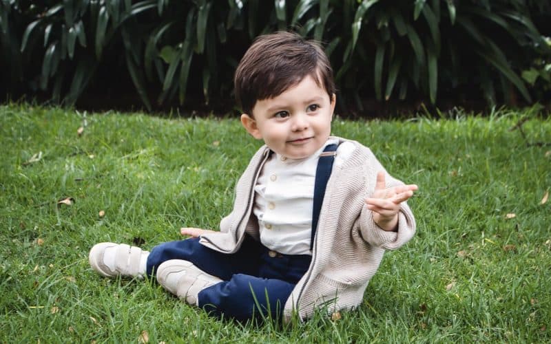 cute toddler sitting on grass