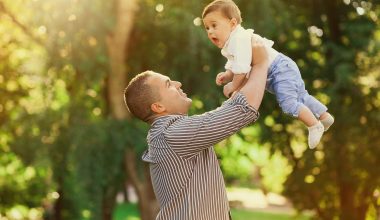 dad carrying baby up in the air