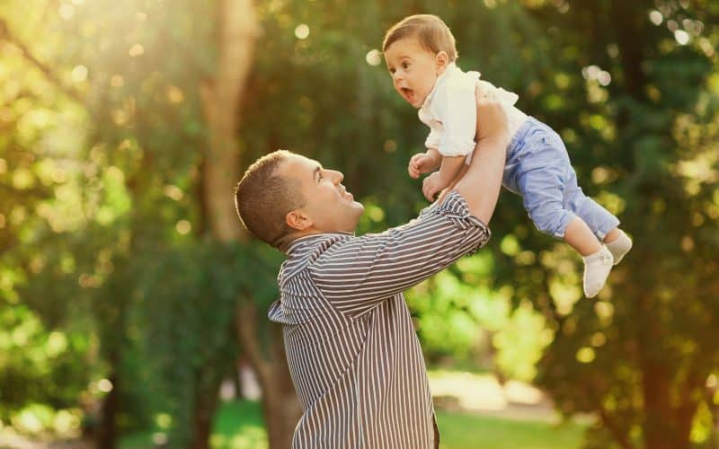 dad carrying baby up in the air