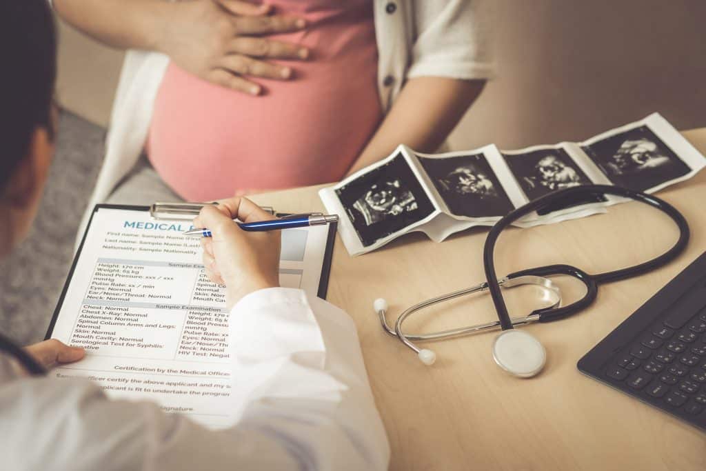 doctor examining pregnant woman