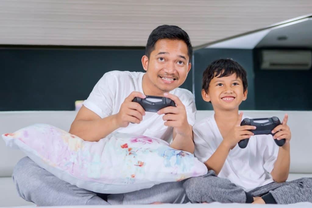 father and son playing video game