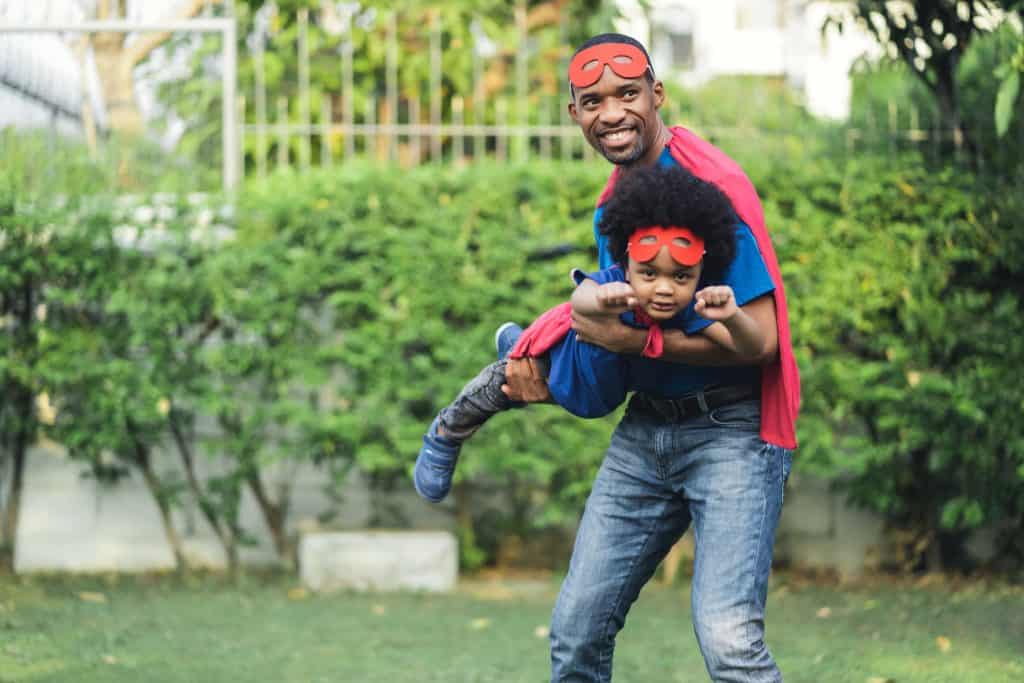 father and son wearing superhero costume