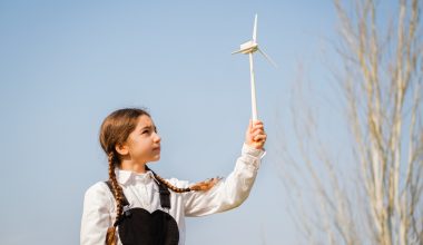 girl playing with a wind turbine