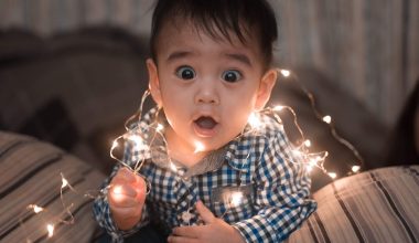 little boy playing with chirstmas lights