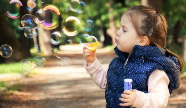 little girl blowing bubbles