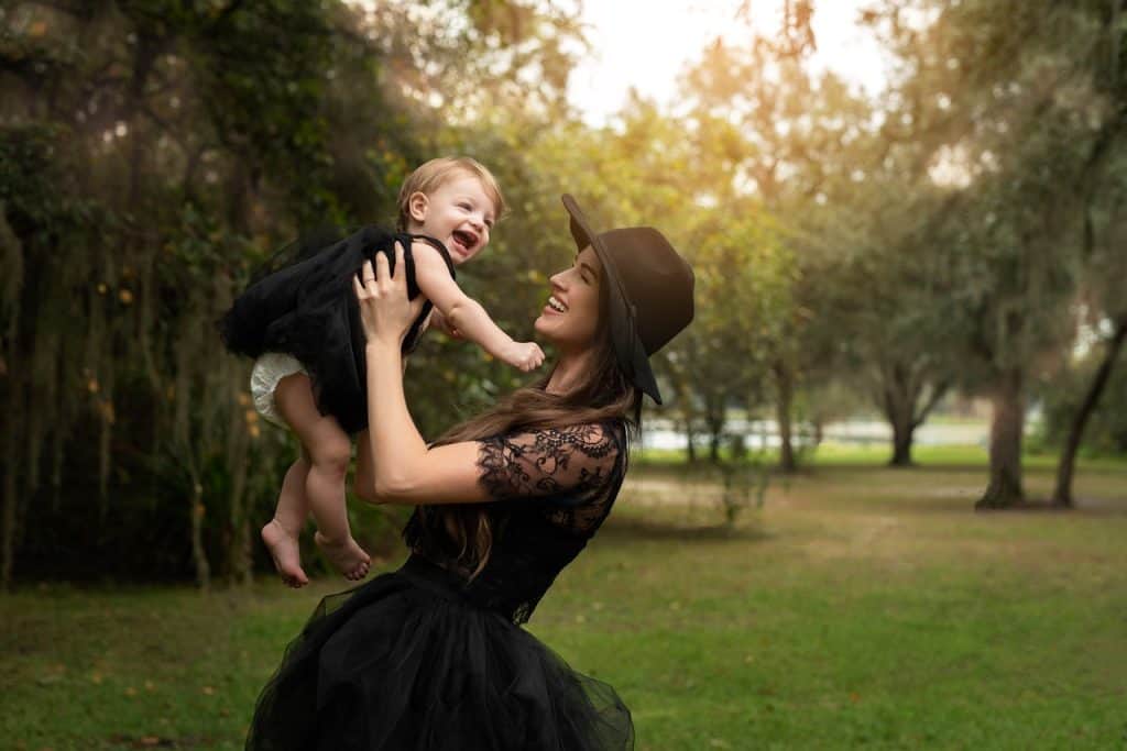 mom carrying baby girl