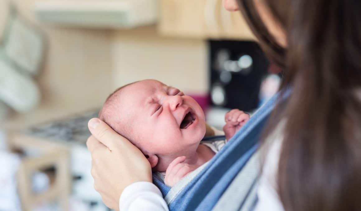 mom carrying crying baby