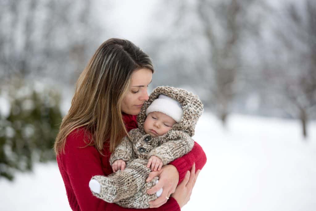 mom holding baby outdoors