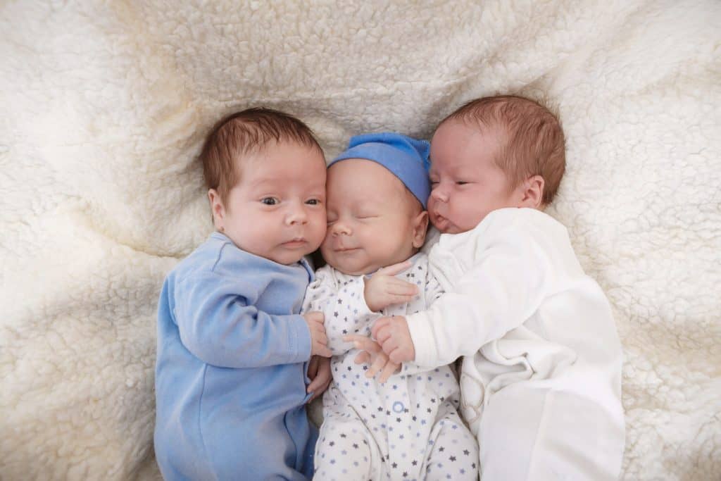 three babies hugging