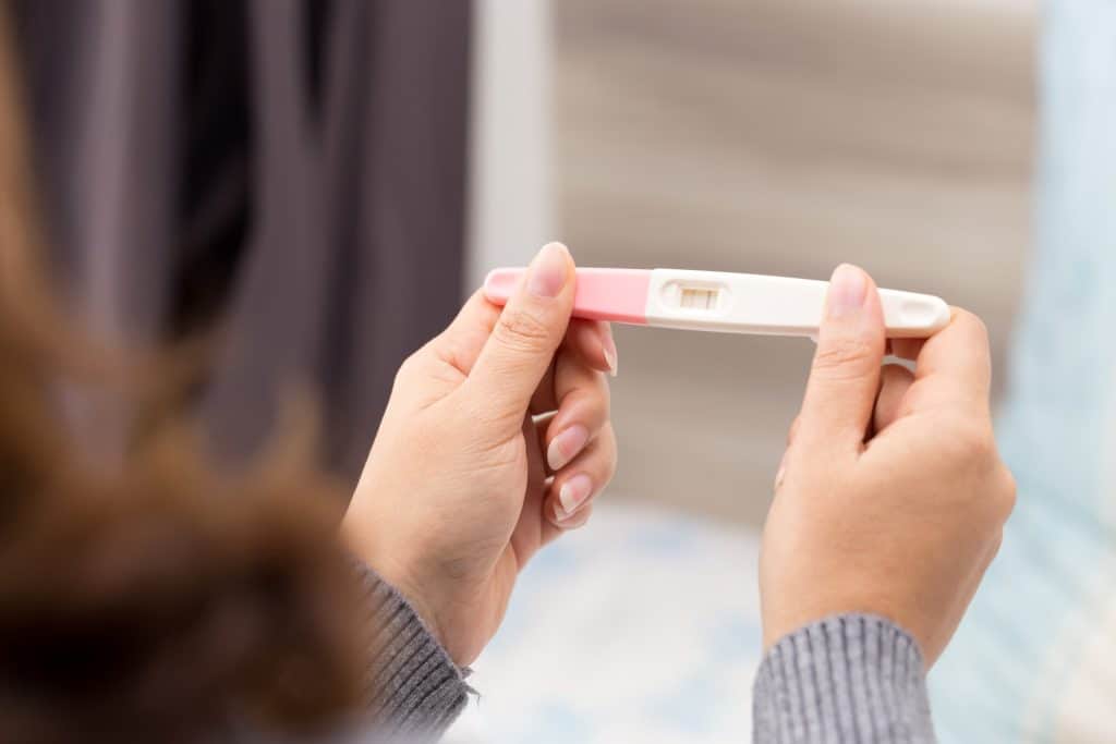 woman looking at pregnancy test