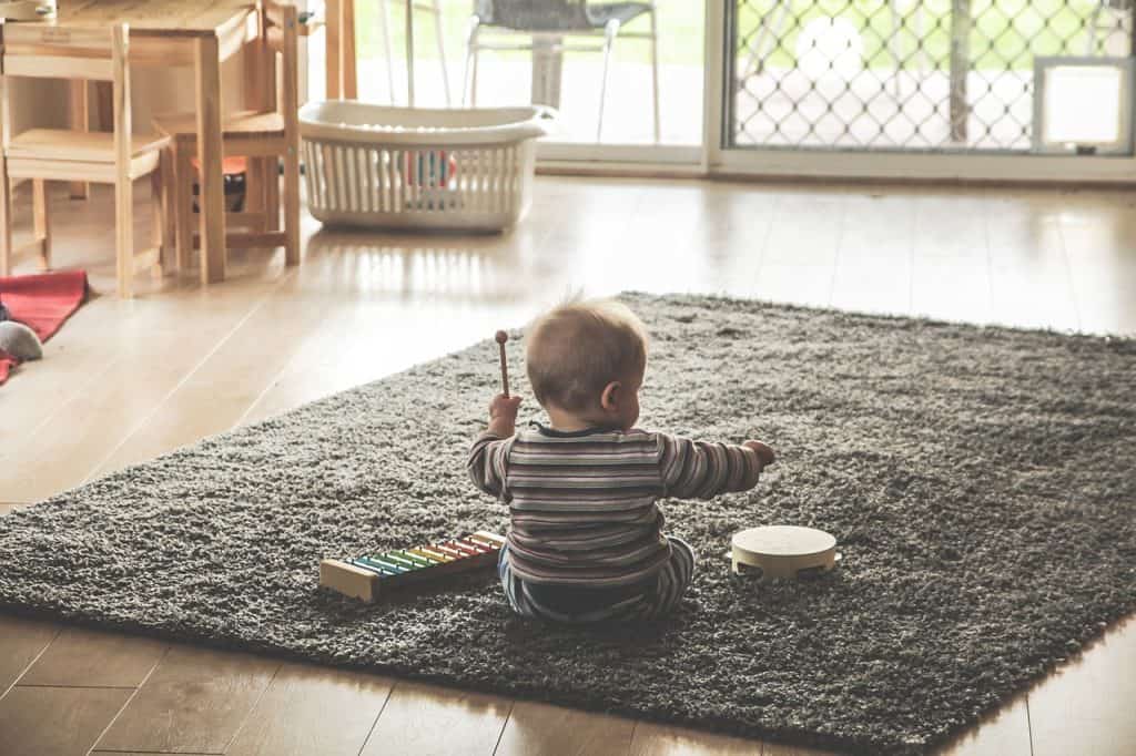 baby playing with tambourine