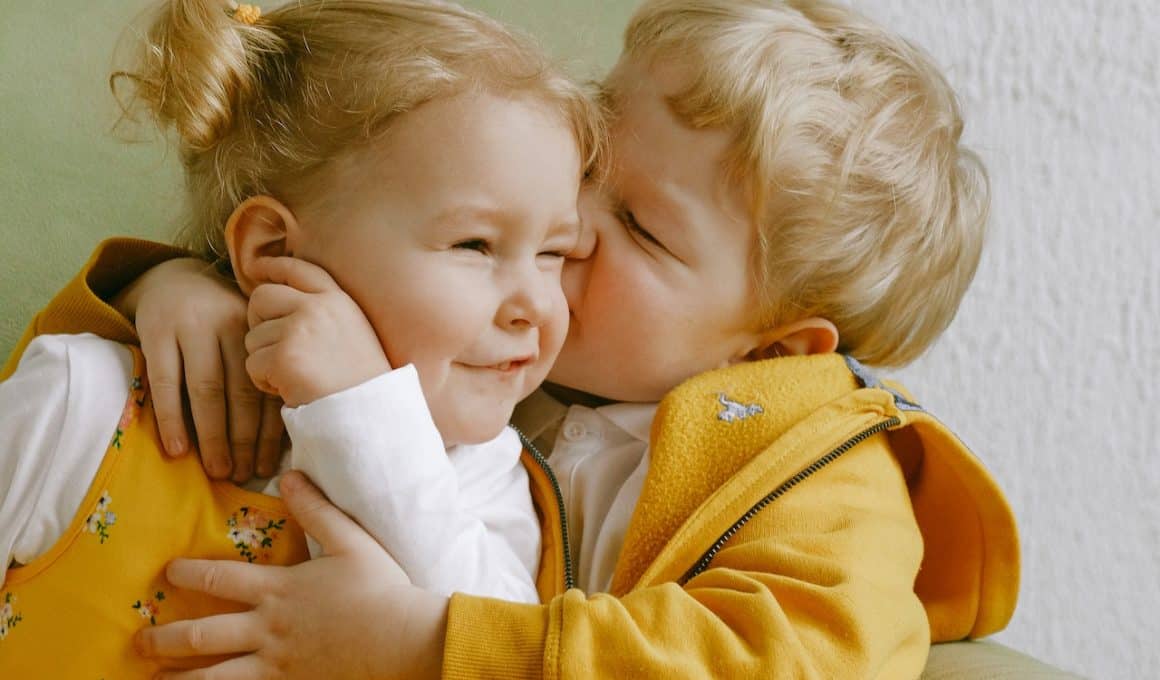 boy kissing his sister