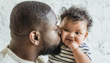 dad kissing baby boy