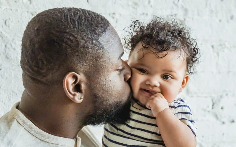 dad kissing baby boy