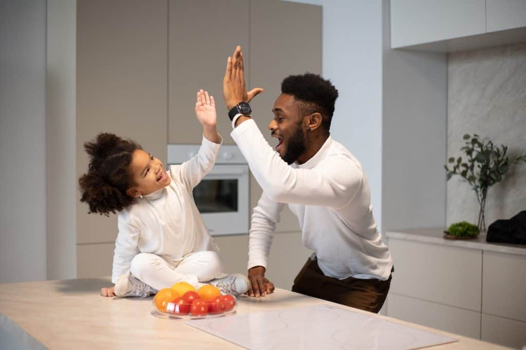 father and daughter high fiving