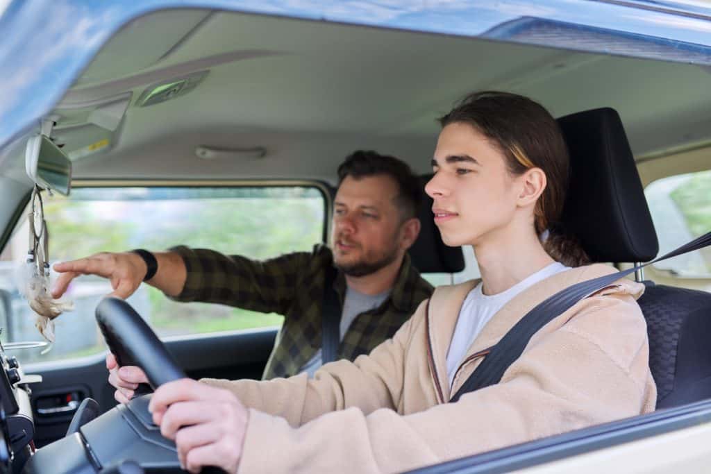 father teaching son how to drive