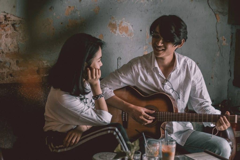 girl getting serenaded by young man